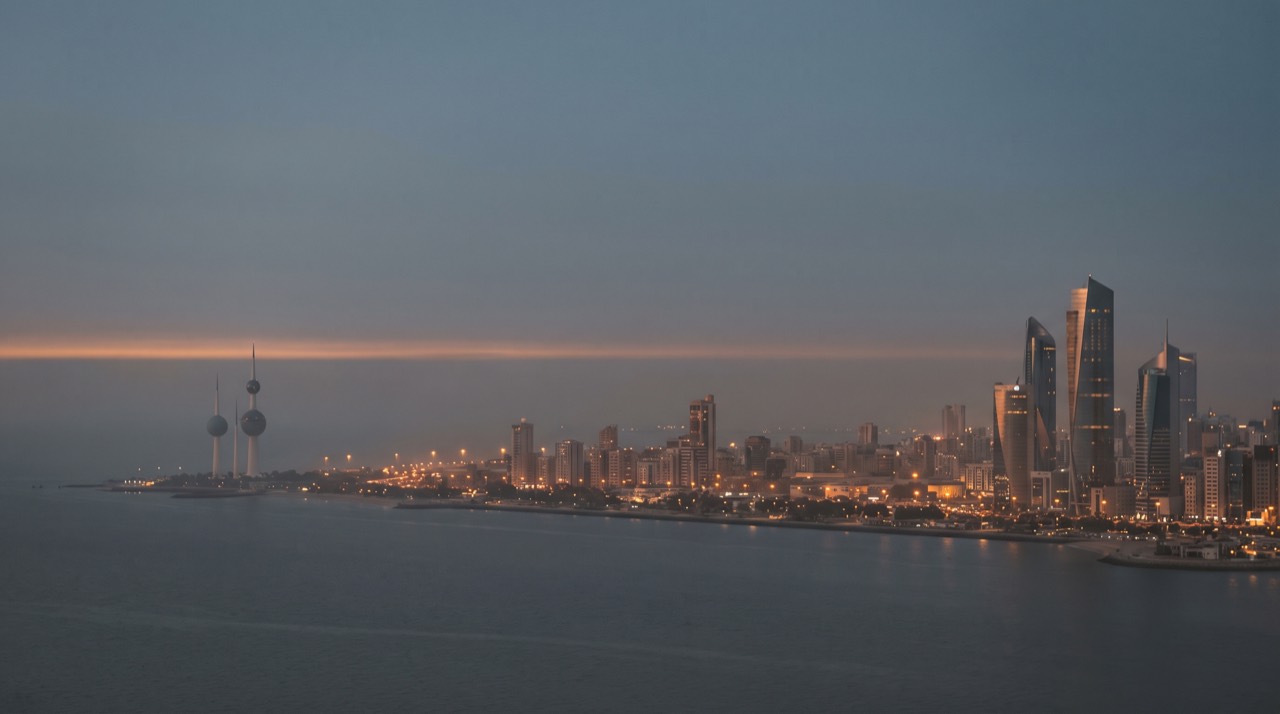 Kuwait City skyline across the bay at dusk